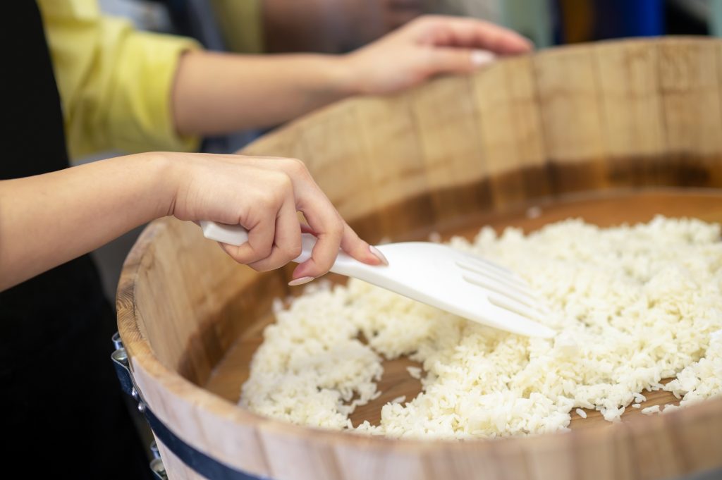 Preparation. Woman praparing rice for sushi in the restaurants kitchen